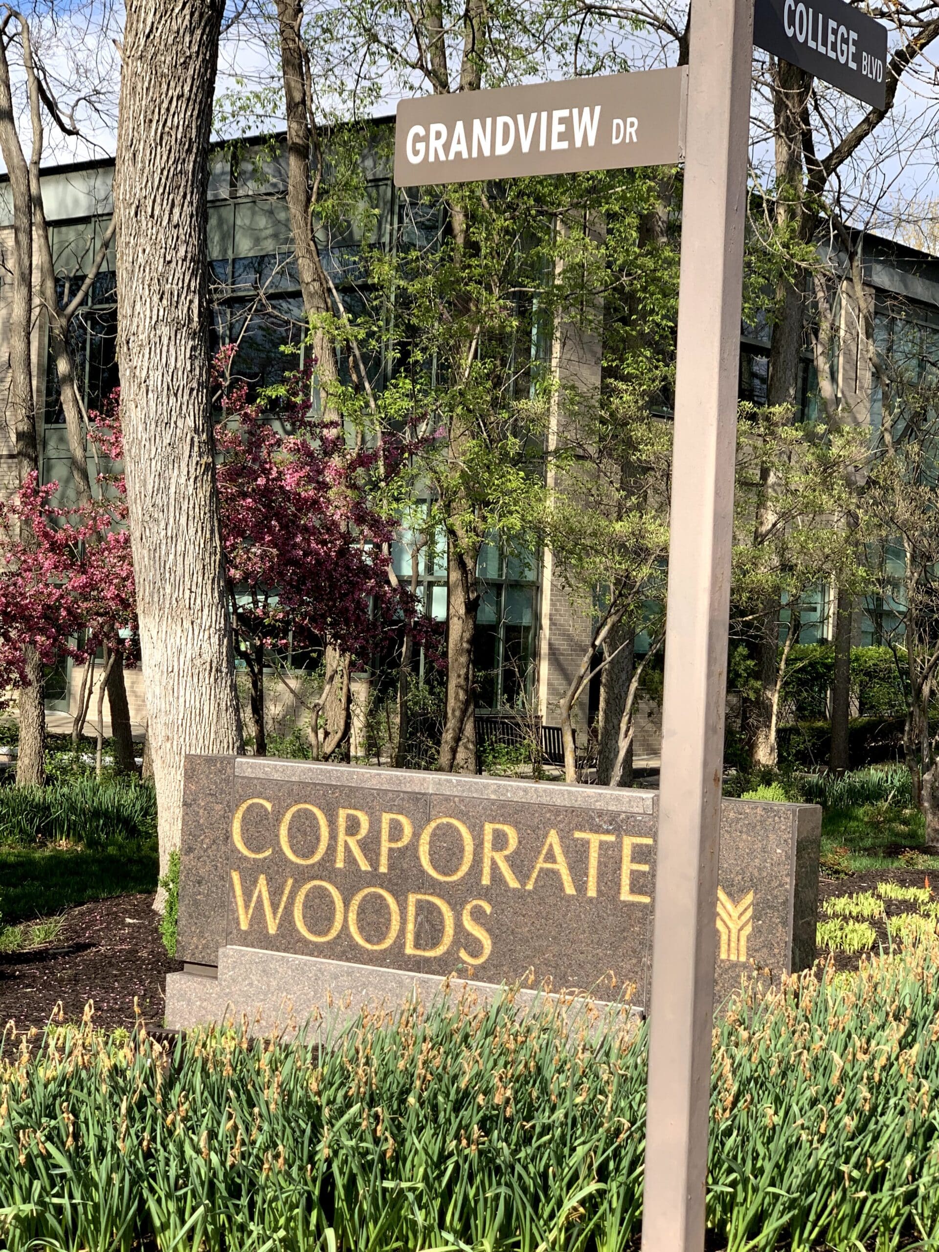 A street sign for Grandview Drive and College Boulevard outside the Corporate Woods office park, location of Daniel Gould, financial advisor in Overland Park, KS, at the Three Streams Financial office.