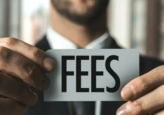 Advisor holding small card that says FEES reminding investors to know the benefits of fee-only over commissioned brokers